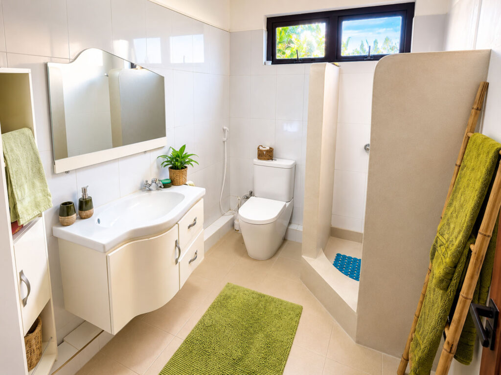 Salle de bain lumineuse avec douche, vasque et serviettes à Villa Zoli Baz, La Preneuse